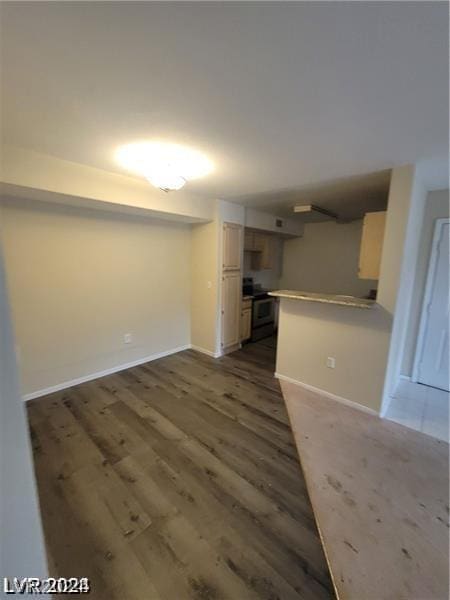 unfurnished living room with dark wood-type flooring