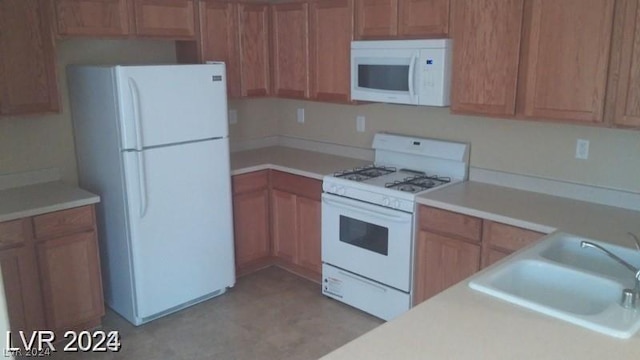 kitchen with sink and white appliances