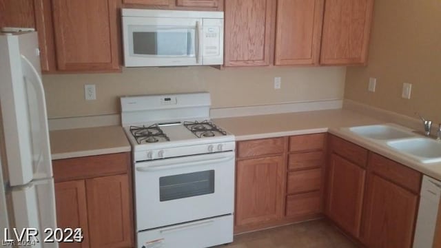 kitchen with sink and white appliances