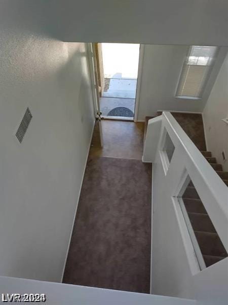 corridor with dark colored carpet