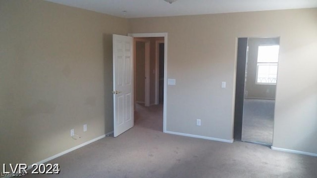 unfurnished bedroom featuring light carpet