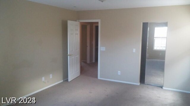 unfurnished bedroom featuring light colored carpet