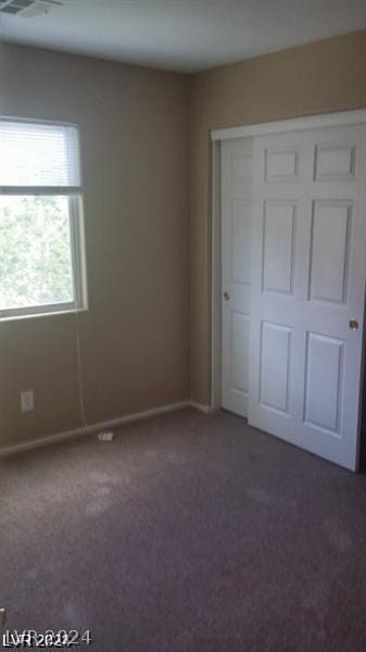 unfurnished bedroom with dark carpet