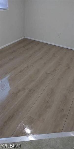 unfurnished room with hardwood / wood-style floors