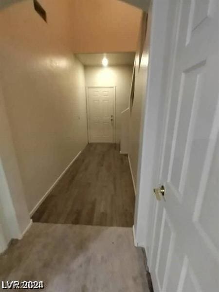 hallway with hardwood / wood-style flooring