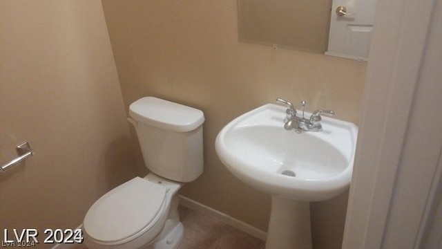 bathroom featuring tile patterned floors and toilet