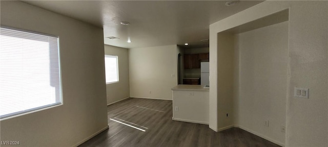 unfurnished living room with dark hardwood / wood-style floors