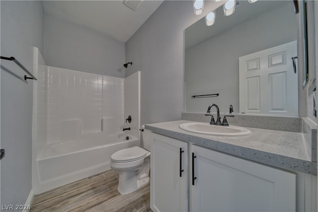 full bathroom featuring shower / washtub combination, toilet, vanity, and hardwood / wood-style floors