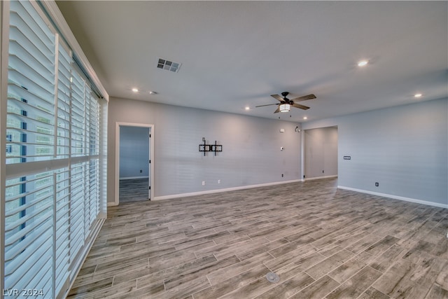 unfurnished living room with light wood-type flooring and ceiling fan