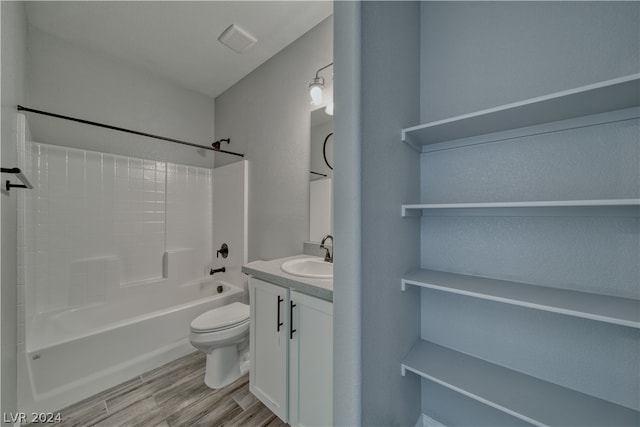 full bathroom featuring vanity, hardwood / wood-style flooring,  shower combination, and toilet