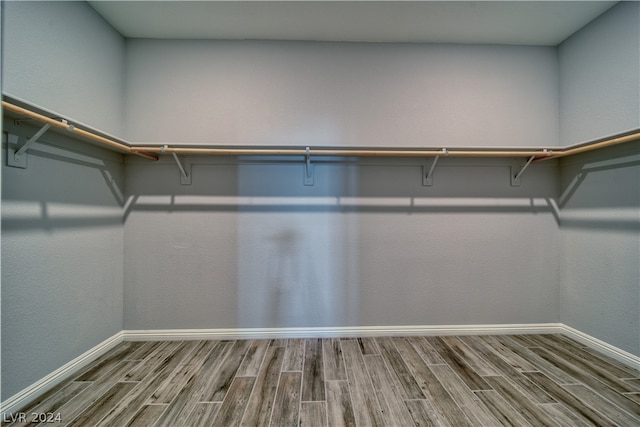 spacious closet featuring hardwood / wood-style flooring