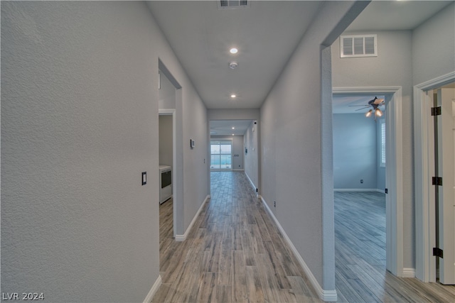 corridor with hardwood / wood-style flooring