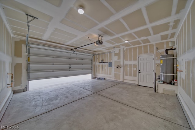 garage with strapped water heater and a garage door opener