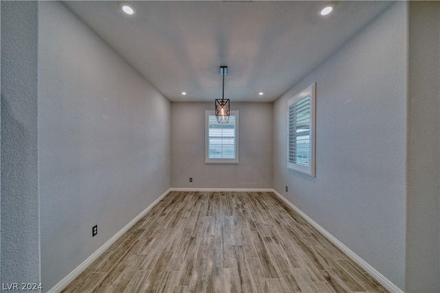 unfurnished dining area featuring light wood-type flooring