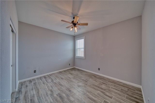 unfurnished room with light wood-type flooring and ceiling fan