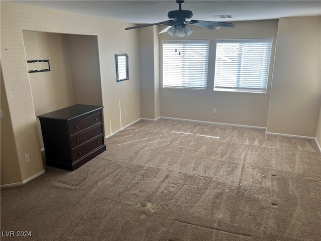 interior space with light carpet and ceiling fan