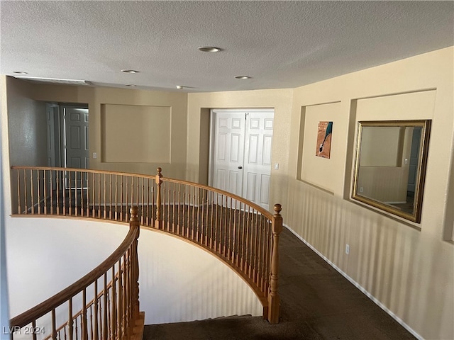 corridor featuring a textured ceiling