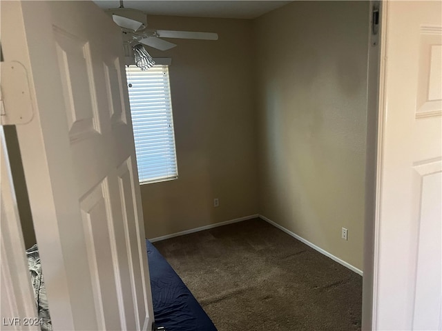 unfurnished room with ceiling fan and carpet