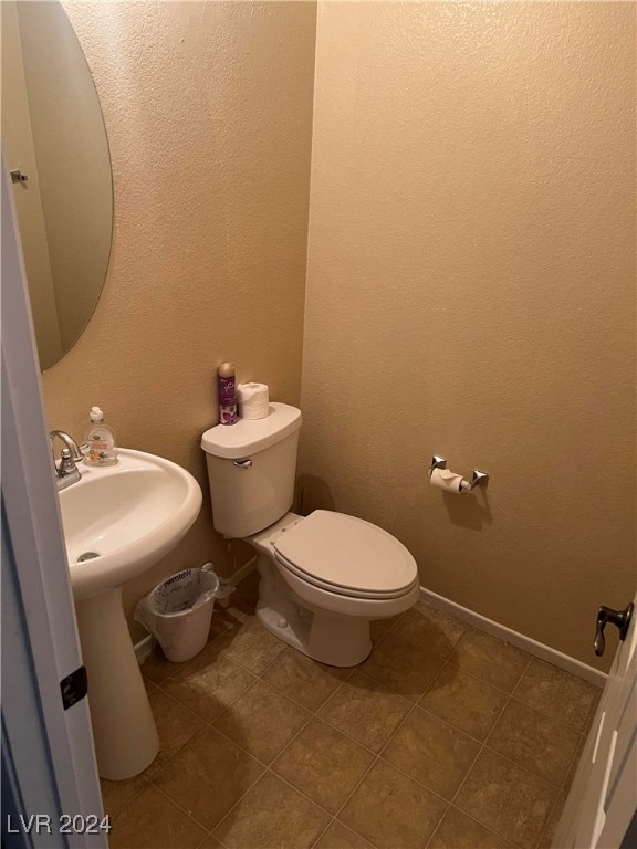 bathroom with sink, tile patterned floors, and toilet