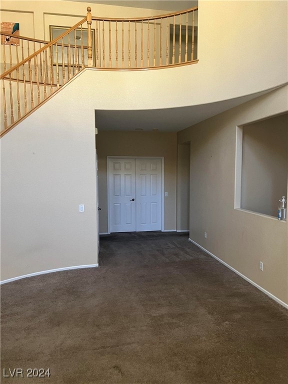 interior space featuring dark colored carpet