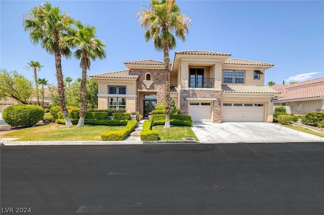 mediterranean / spanish-style home with stone siding, concrete driveway, an attached garage, and stucco siding