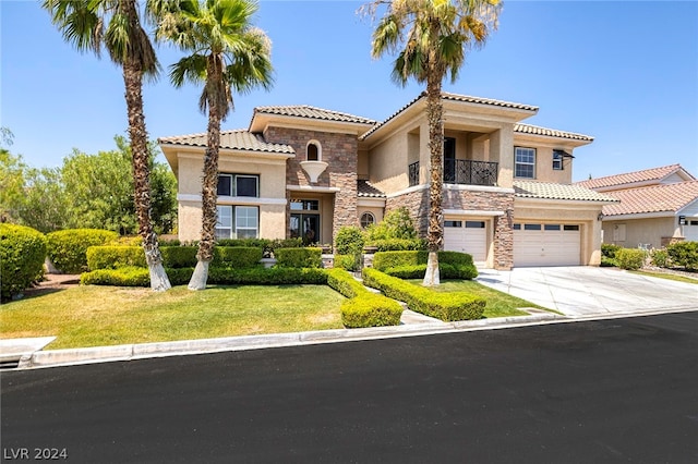 mediterranean / spanish-style house with a garage and a front lawn