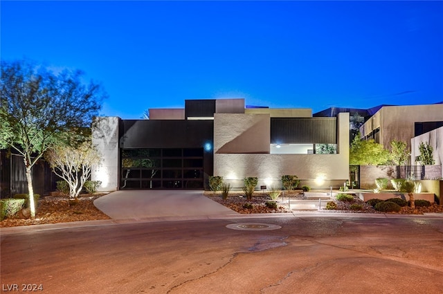 pueblo revival-style home with a balcony