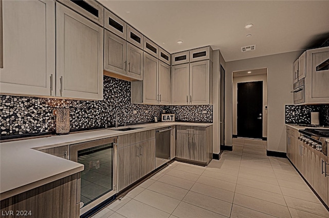 kitchen with sink, tasteful backsplash, light tile patterned floors, and wine cooler