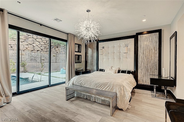 bedroom with access to outside, light hardwood / wood-style flooring, and a chandelier