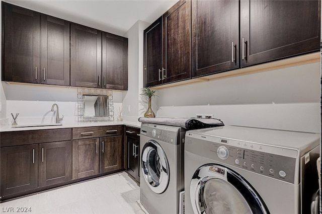 laundry room with cabinets, washing machine and dryer, sink, and light tile patterned flooring