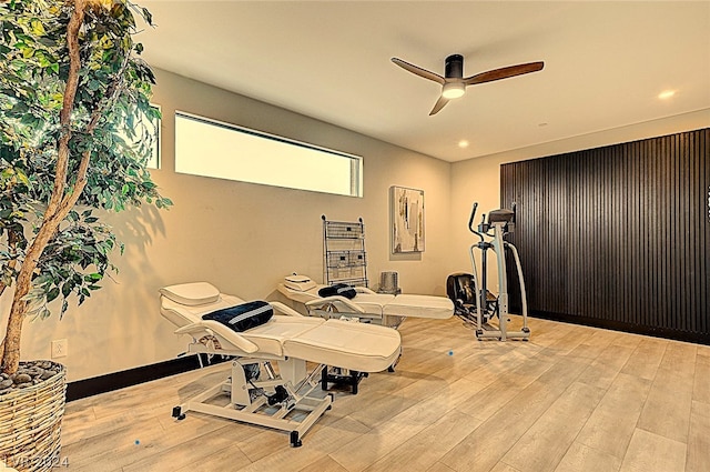 exercise area featuring ceiling fan and light wood-type flooring