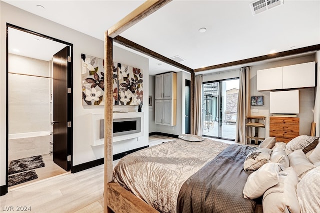 bedroom featuring light wood-type flooring and access to outside