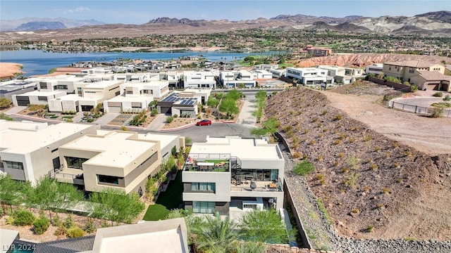 drone / aerial view featuring a water and mountain view