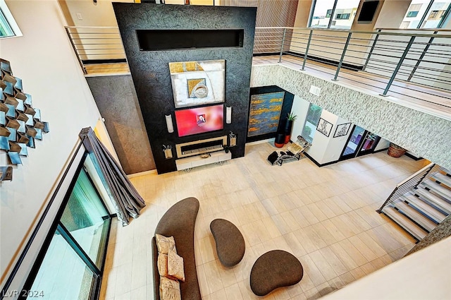 tiled living room with a high ceiling