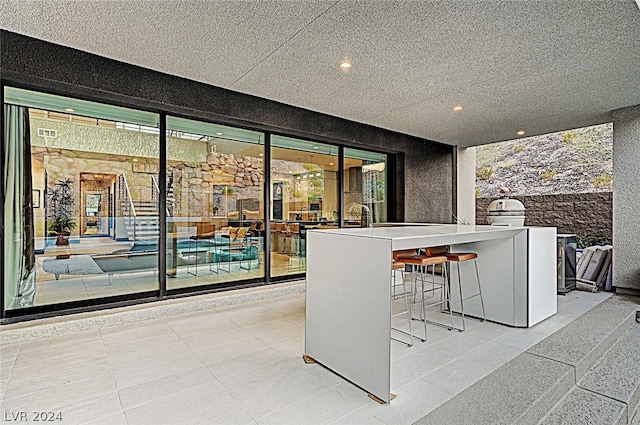 view of patio / terrace featuring a bar and area for grilling