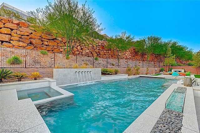 view of swimming pool featuring an in ground hot tub and pool water feature