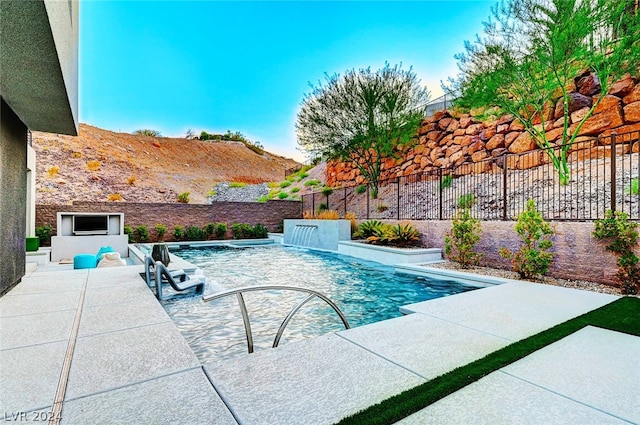 view of swimming pool featuring a patio and pool water feature