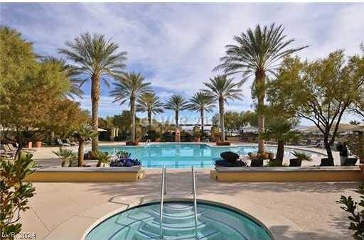 view of pool featuring a patio area and a hot tub