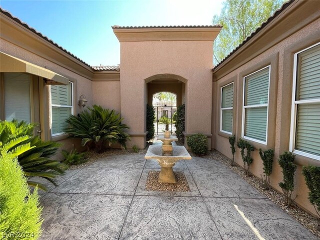 property entrance featuring a patio