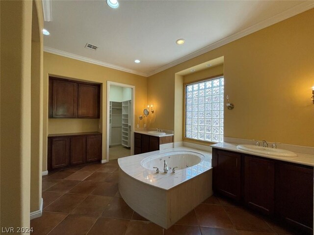 bathroom featuring tile patterned flooring, a tub, double sink vanity, and ornamental molding