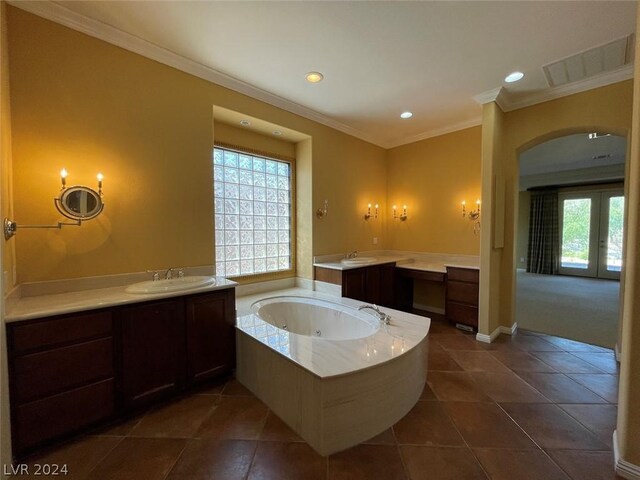 bathroom featuring vanity, tile patterned flooring, a bath, and crown molding