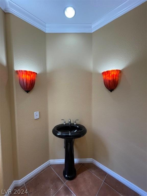 interior space with crown molding and tile patterned floors