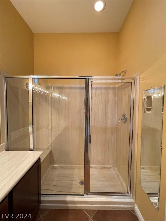 bathroom with tile patterned flooring and walk in shower