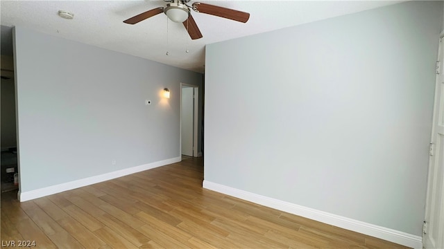 unfurnished room featuring ceiling fan, a textured ceiling, and light wood-type flooring