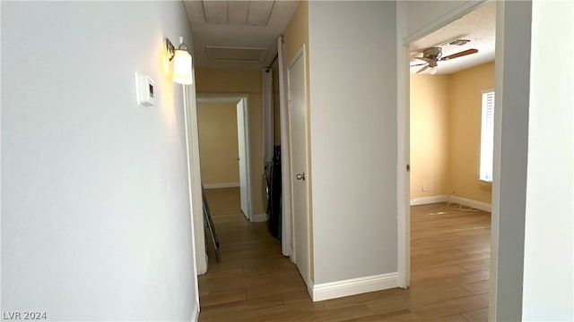 corridor with light wood-type flooring