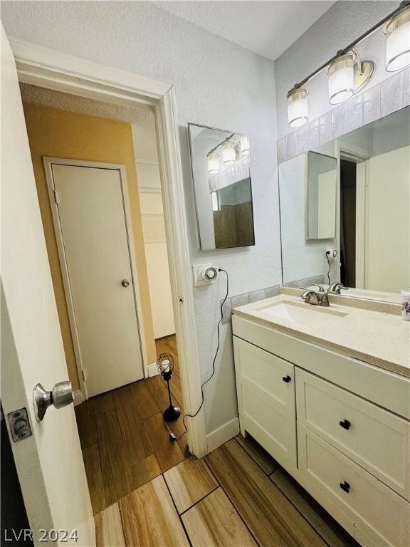 bathroom featuring vanity and hardwood / wood-style floors