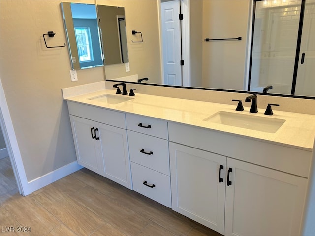 bathroom with hardwood / wood-style floors and vanity