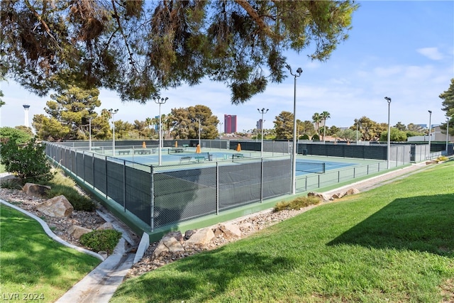 view of sport court featuring a lawn