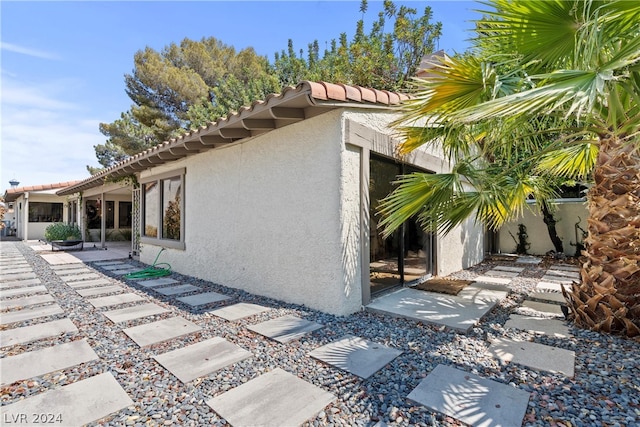 view of property exterior featuring a patio