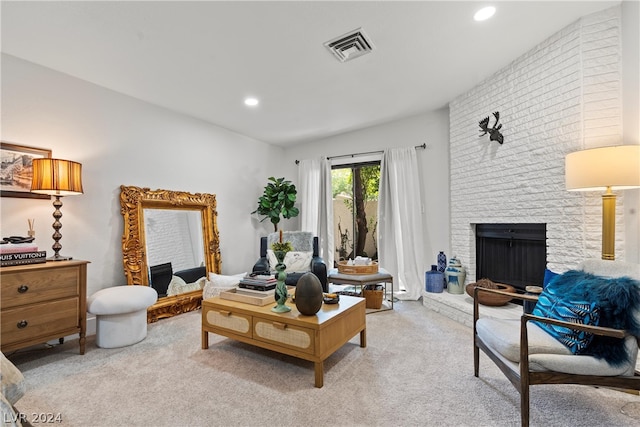 living room with light colored carpet and a fireplace